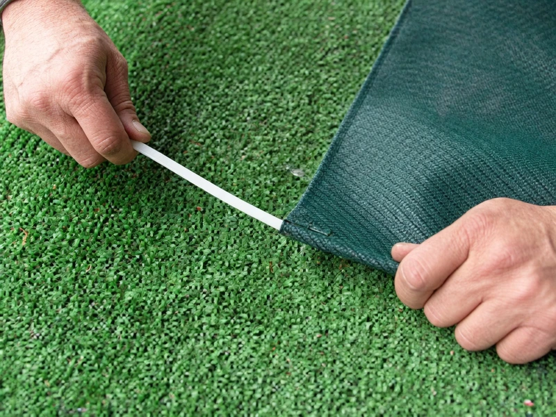 Insert the plastic retaining rods into the new sling material